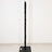 Black scratching post with a sturdy base, ideal for cats.