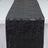 Black textured fabric table runner on white background