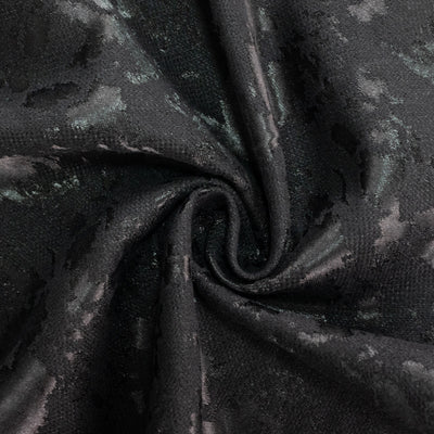 Black textured fabric with glossy swirl pattern close-up#whtbkgd