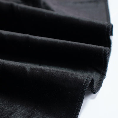 Black velvet fabric swatches stacked on a white background