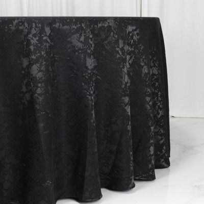 Black velvet tablecloth draped over a table in a minimalist white room
