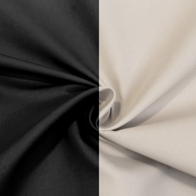 Black and beige fabric swirl, showcasing smooth texture and contrasting colors. #whtbkgd