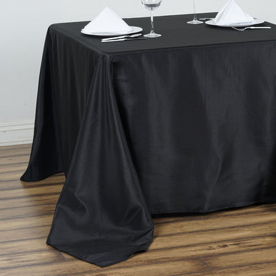 Black tablecloth draped over a table, ideal for dining settings.