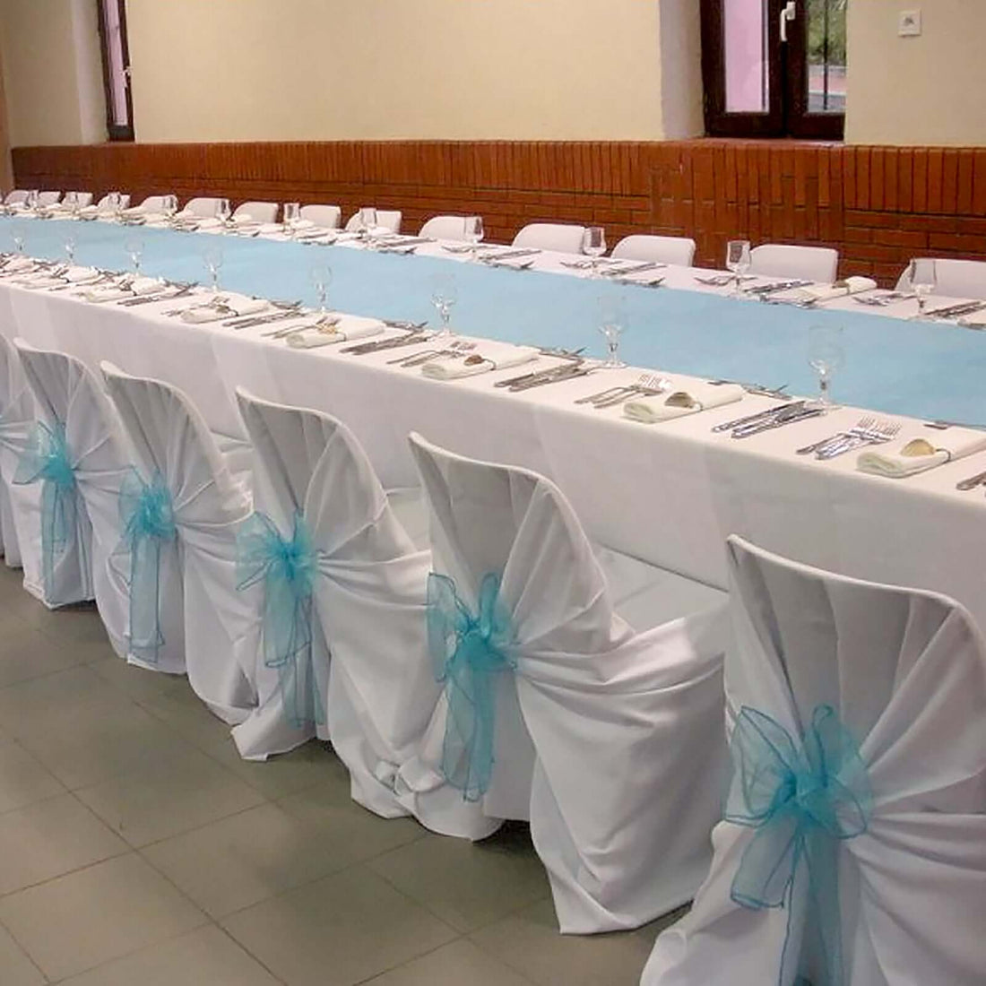 White polyester universal chair cover with a loose draped self-tie design