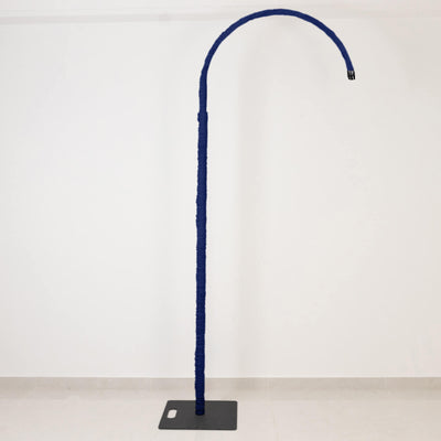 Blue curved floor lamp with tall fabric-wrapped stem on black base