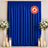 Blue flame retardant curtain with floral stands and candles event backdrop