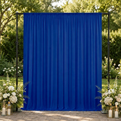 Blue outdoor wedding backdrop with floral arrangements and lanterns