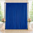 Blue wedding backdrop curtain with floral arrangements and candles