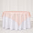 Blush pink round tablecloth overlay on white round table setting