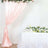 Blush pink draped curtain backdrop with floral garland and table
