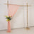 Wooden arch with pink drapery and floral arrangement