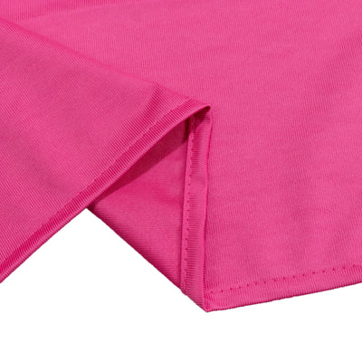 Bright pink ribbed fabric close-up with folded edge and seam detail