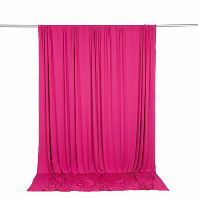 Bright pink satin curtain draped on a backdrop stand