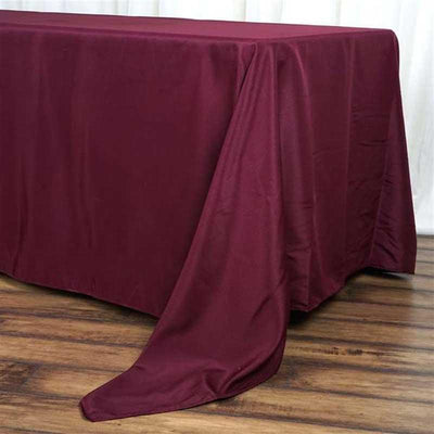 Burgundy tablecloth draped elegantly over a wooden table.