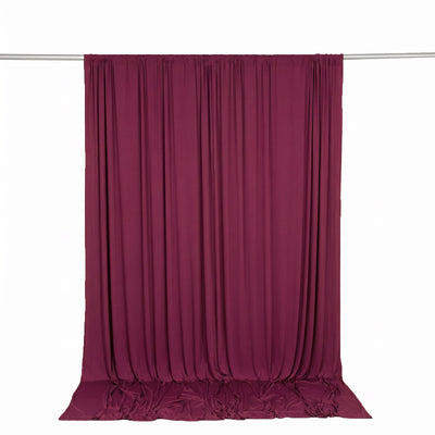 Burgundy fabric backdrop curtain on rod, isolated on white background