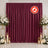Burgundy flame retardant event curtain backdrop with floral candle decor