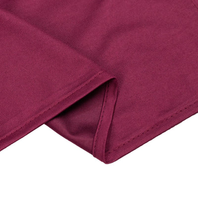 Burgundy ribbed knit fabric close-up with folded hem