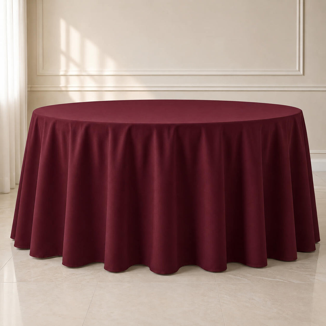 Burgundy round tablecloth draped elegantly on a table.