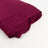 Burgundy fabric roll on white backdrop