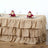 Burlap table skirt with ruffles for elegant dining setups.