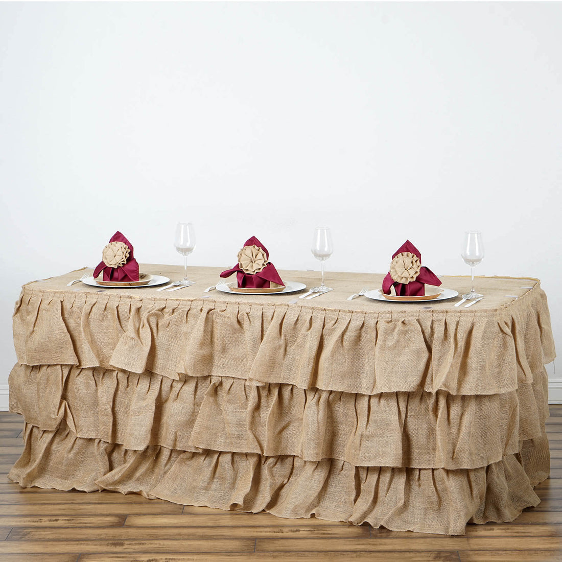 Burlap table skirt with ruffled design for elegant dining setups.