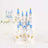 Miniature white castle model with blue rooftops and golden accents