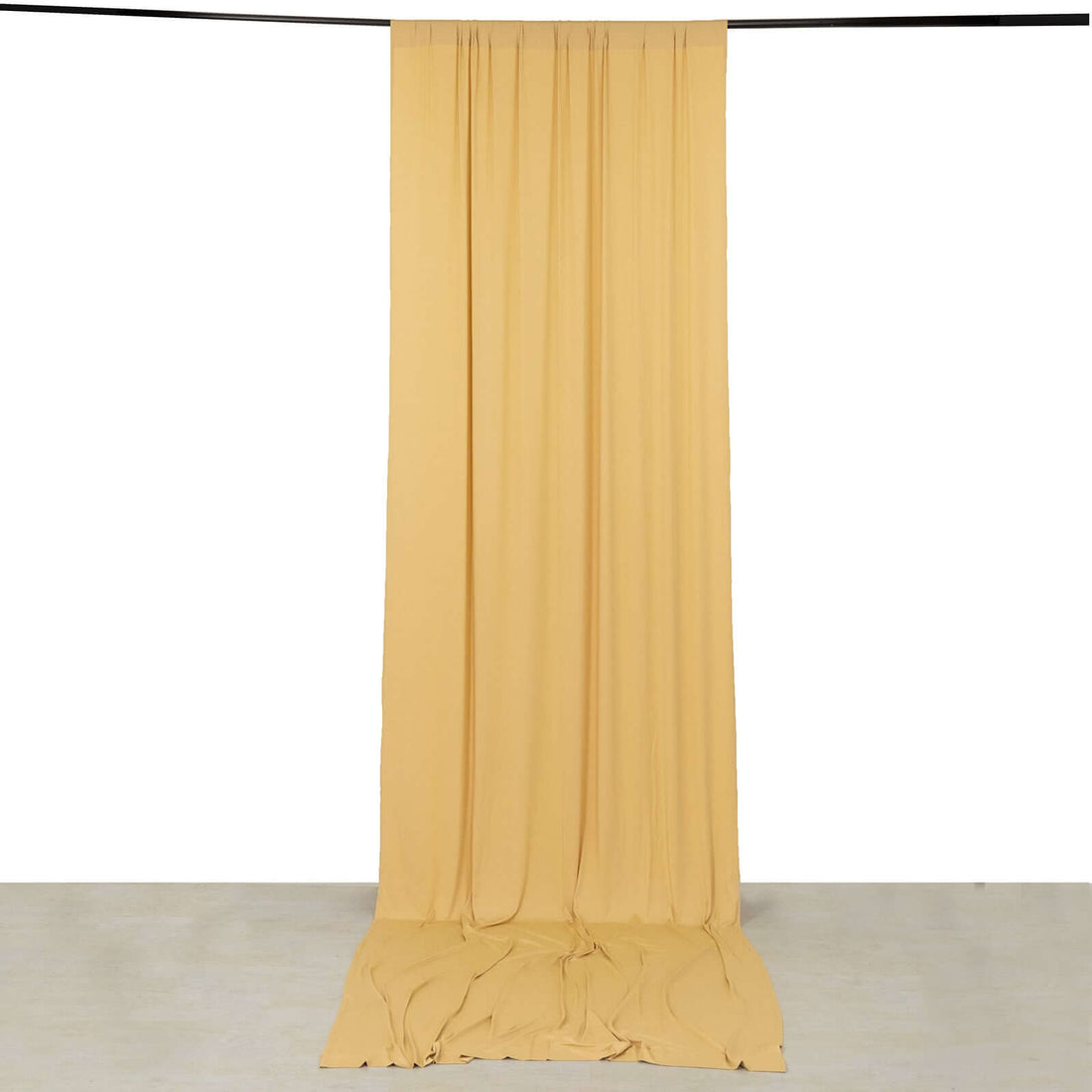 Yellow fabric backdrop draping elegantly in a studio setting.