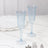 Elegant blue fluted champagne glasses on a marble table.