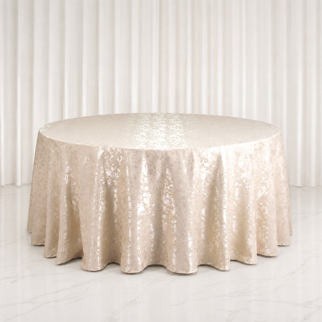 Champagne round banquet table with luxe jacquard tablecloth