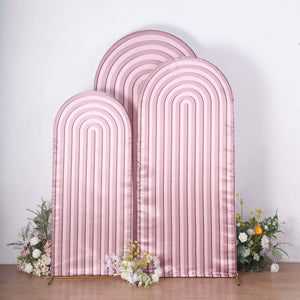 Pink arch backdrop with stripes and floral accents.