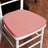 Pink cushion for chair seat, providing comfort and style.