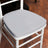 Gray chair cushion on a white chair against a wooden floor