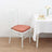 White chiavari chair with pink cushion beside a dining table.