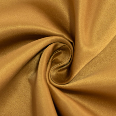 Golden brown fabric swirl showcasing smooth texture. #whtbkgd
