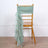 Mint green chair sash draped elegantly over a wooden chair.