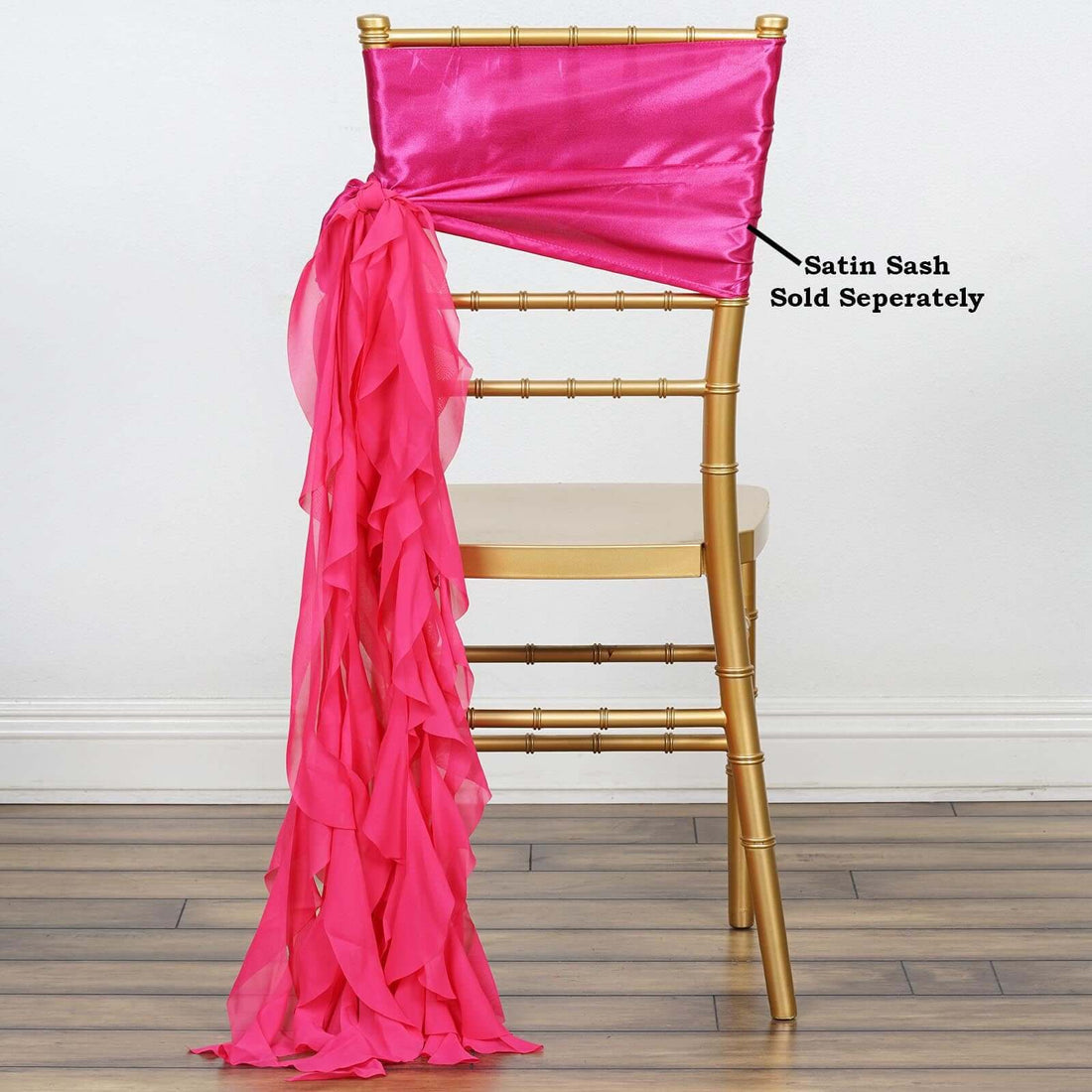 Gold chiavari chair with pink satin sash draped elegantly on back.