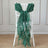 Green chiffon chair sash draped elegantly on a white chair.