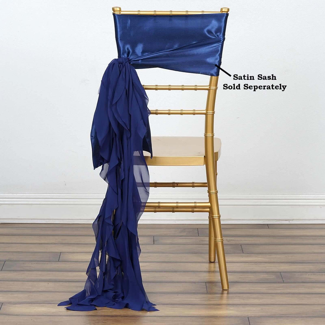 Gold chiavari chair with navy satin sash draped over the back.
