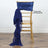 Gold chiavari chair with navy satin sash draped over the back.