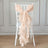 Peach chiffon chair sash elegantly tied on a white chair.