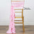 Gold chiavari chair with pink satin sash draped elegantly.