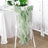 Green chiffon chair sash draped elegantly over a white chair.