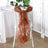 Brown chiffon chair sash draped elegantly on a white chair.