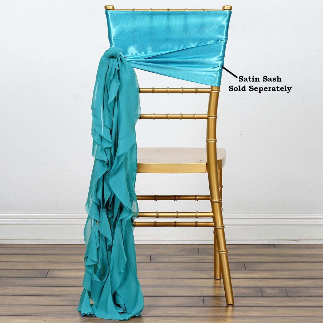 Gold chiavari chair with teal satin sash draped on the back.