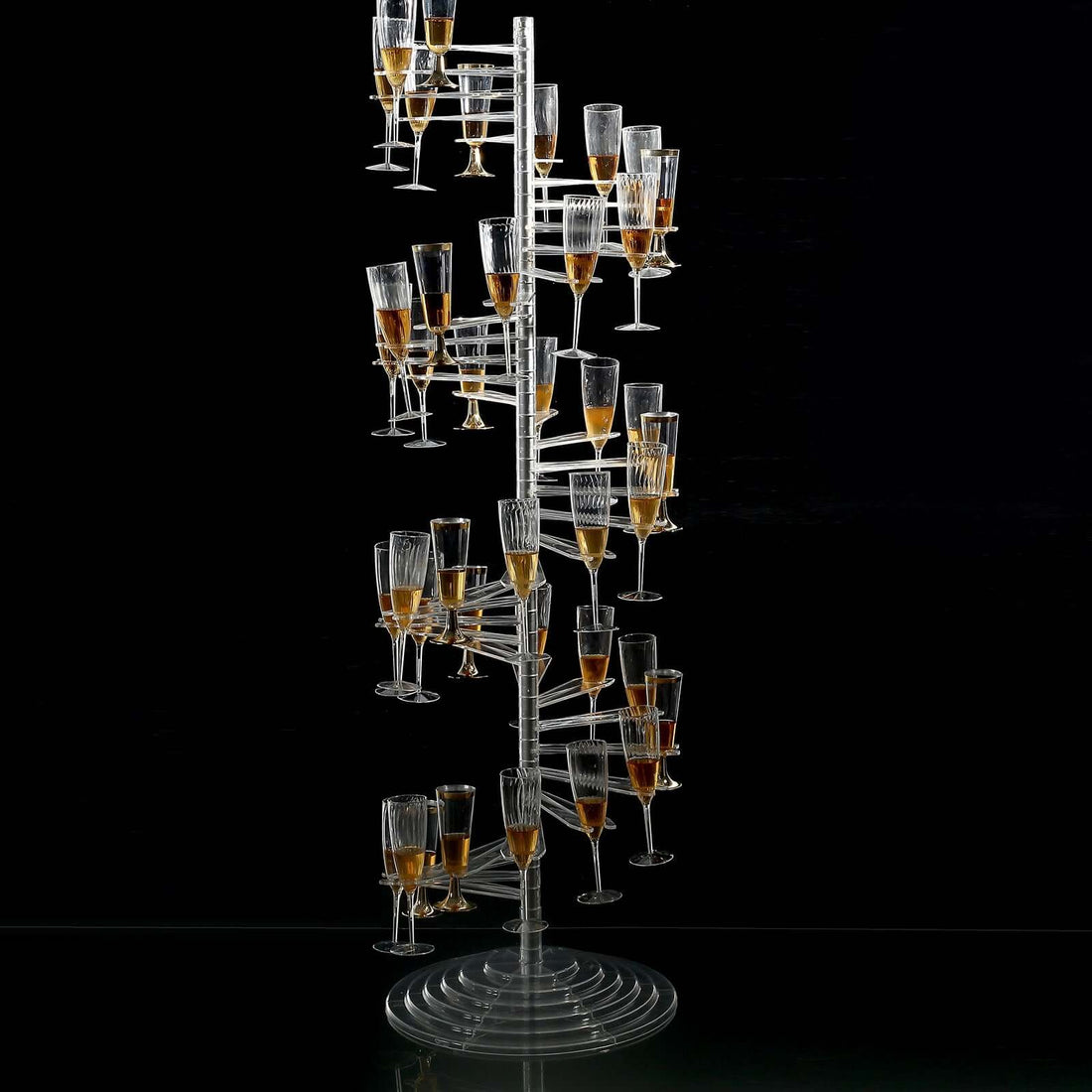 Champagne tower with glasses filled, elegantly displayed on a dark backdrop.