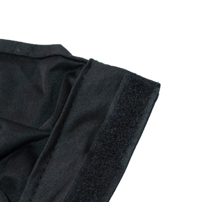 Close-up of black fabric seam with velcro fastening on white background