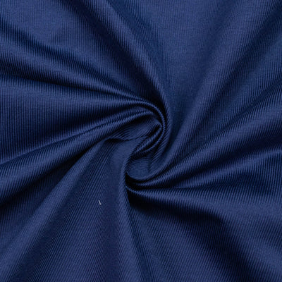 Close-up of navy blue ribbed fabric with soft twisted folds