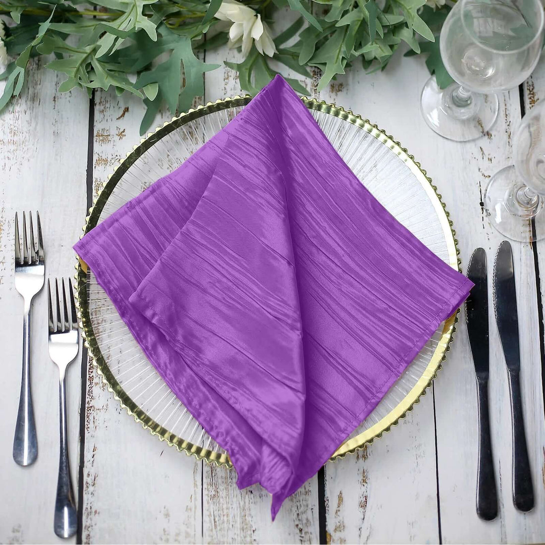 Purple textured napkin elegantly arranged on a plate with cutlery. #whtbkgd