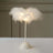 White feather lamp with a sleek base, perfect for stylish decor.