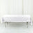 White tablecloth draped over a folding table in studio setting.
